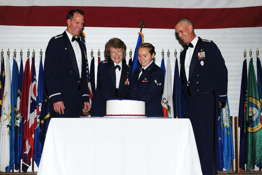 A cake is cut by the oldest and youngest members of Team Minot along with both wing commanders at Minot Air Force Base, N.D., Sept. 17, 2016. Minot AFB hosted the ball to celebrate 69 years of the Air Force. (U.S. Air Force photo/Senior Airman Kristoffer Kaubisch)