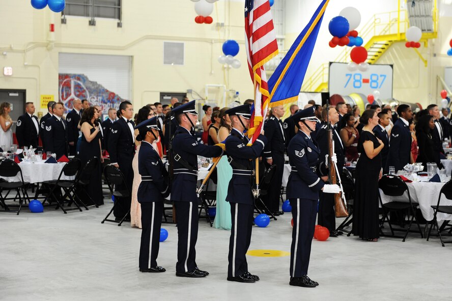 Honor Guard members stand in formation with the American Flag as the national anthem is sang at Minot Air Force Base, N.D., Sept. 17, 2016. Minot AFB hosted the ball to celebrate 69 years of the Air Force. (U.S. Air Force photo/Senior Airman Kristoffer Kaubisch)