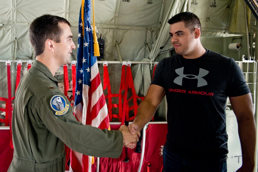 Armando McClarty shakes hands with U.S. Air Force Reserve 2nd Lt. Evan Draper, C-130J pilot, 327th Airlift Squadron, after taking the oath of enlistment in a C-130J Super Hercules at Little Rock Air Force Base, Ark., Sept. 17, 2016. McClarty, who hails from Houston, Texas, will report for duty at the 327 AS after completing Basic Military Training in Texas, and loadmaster training at Little Rock, AFB. (U.S. Air Force photo by Master Sgt. Jeff Walston/Released)