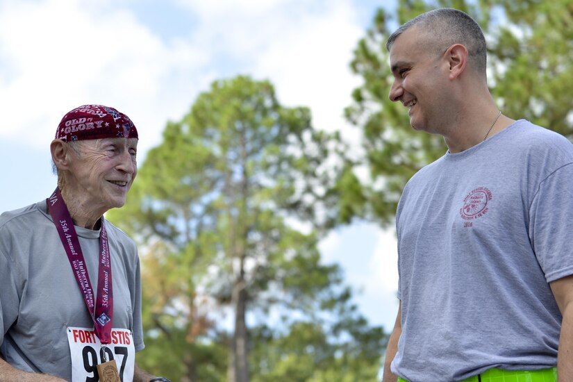 Doug Berry speaks with Command Sgt. Maj. Joel Zecca, 733rd Security Forces Squadron command sergeant major, after the Mulberry Island Half Marathon at Joint Base Langley-Eustis, Va., Sept. 17, 2016. Berry spoke with Zecca about the run and his time in military service.  (U.S. Air Force photo by Staff Sgt. Natasha Stannard/Released)