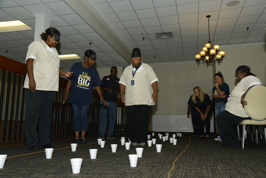 Carolina Pines Inn housekeepers guide each other through a maze of cups during International Housekeepers Week at Shaw Air Force Base, S.C., Sept. 13, 2016. The housekeepers do quarterly team building activities to focus on teamwork and build relationships. (U.S. Air Force photo by Airman BrieAnna Stillman)