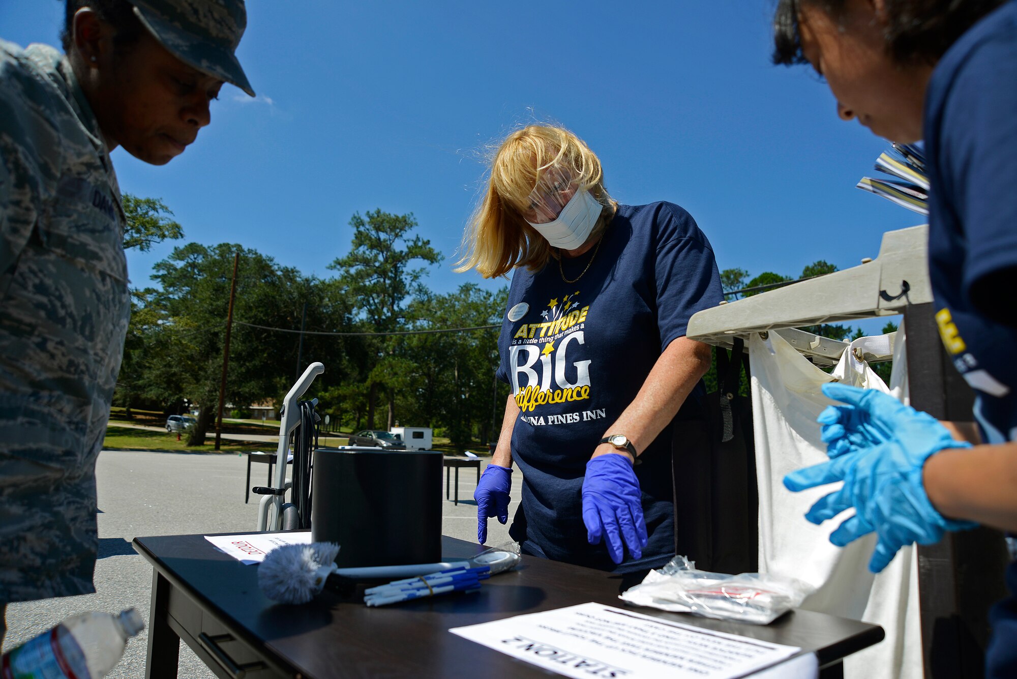 U.S. Air Force Master Sgt. Marretha Davis, 20th Force Support Squadron assistant lodging manager, and Carolina Pines Inn housekeepers work together to win a relay race with multiple obstacles at Shaw Air Force Base, S.C., Sept. 16, 2016. The obstacles consisted of vacuuming a room full of confetti and prepping a cart for cleaning and restocking. (U.S. Air Force photo by Airman BrieAnna Stillman) 