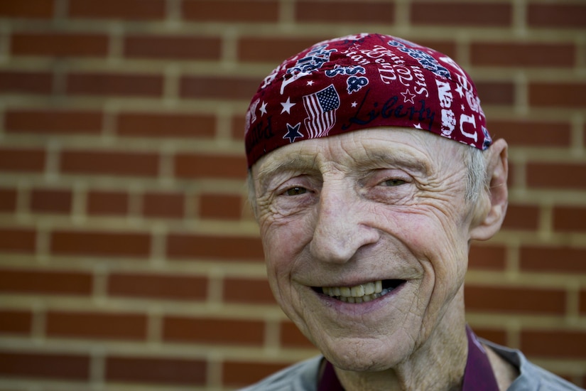 Doug Berry poses for a photo after participating in the Mulberry Island Half Marathon at Joint Base Langley-Eustis, Va., Sept. 17, 2016. Each year, Berry wears a matching patriotic bandana and scarf made by his wife. (U.S. Air Force photo by Staff Sgt. Natasha Stannard/Released)