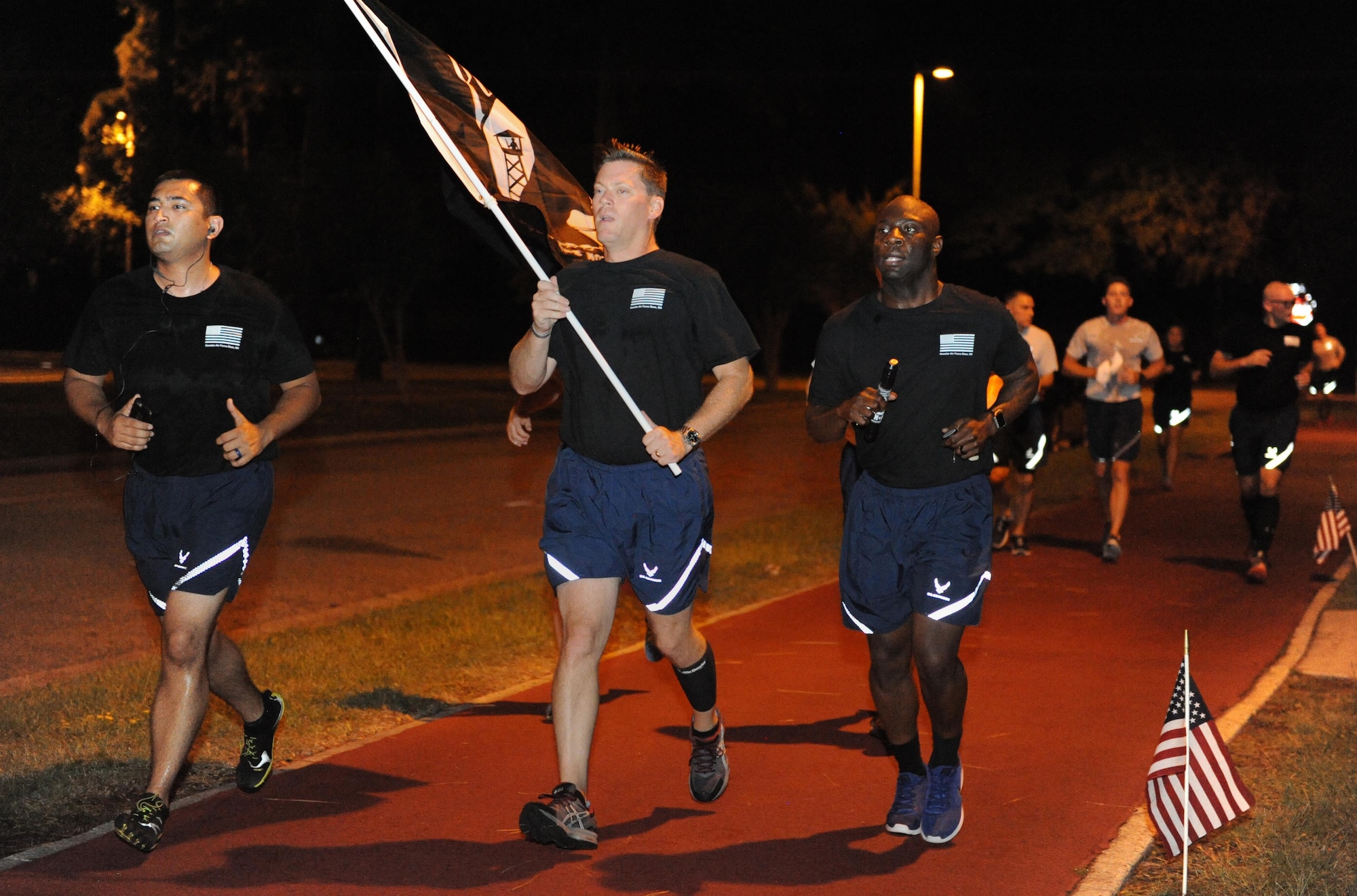 Col. C. Mike Smith, 81st Training Wing vice commander, and Chief Master Sgt. Vegas Clark, 81st TRW command chief, run the final laps during Keesler’s POW/MIA 24-hour memorial run and vigil at the Crotwell Track Sept. 16, 2016, on Keesler Air Force Base, Miss. More than 400 Keesler personnel participated in the event, to include runners and readers. Participants ran more than 1,500 miles and raised $1,400, which will be donated to a POW/MIA memorial fund. (U.S. Air Force photo by Kemberly Groue/Released)