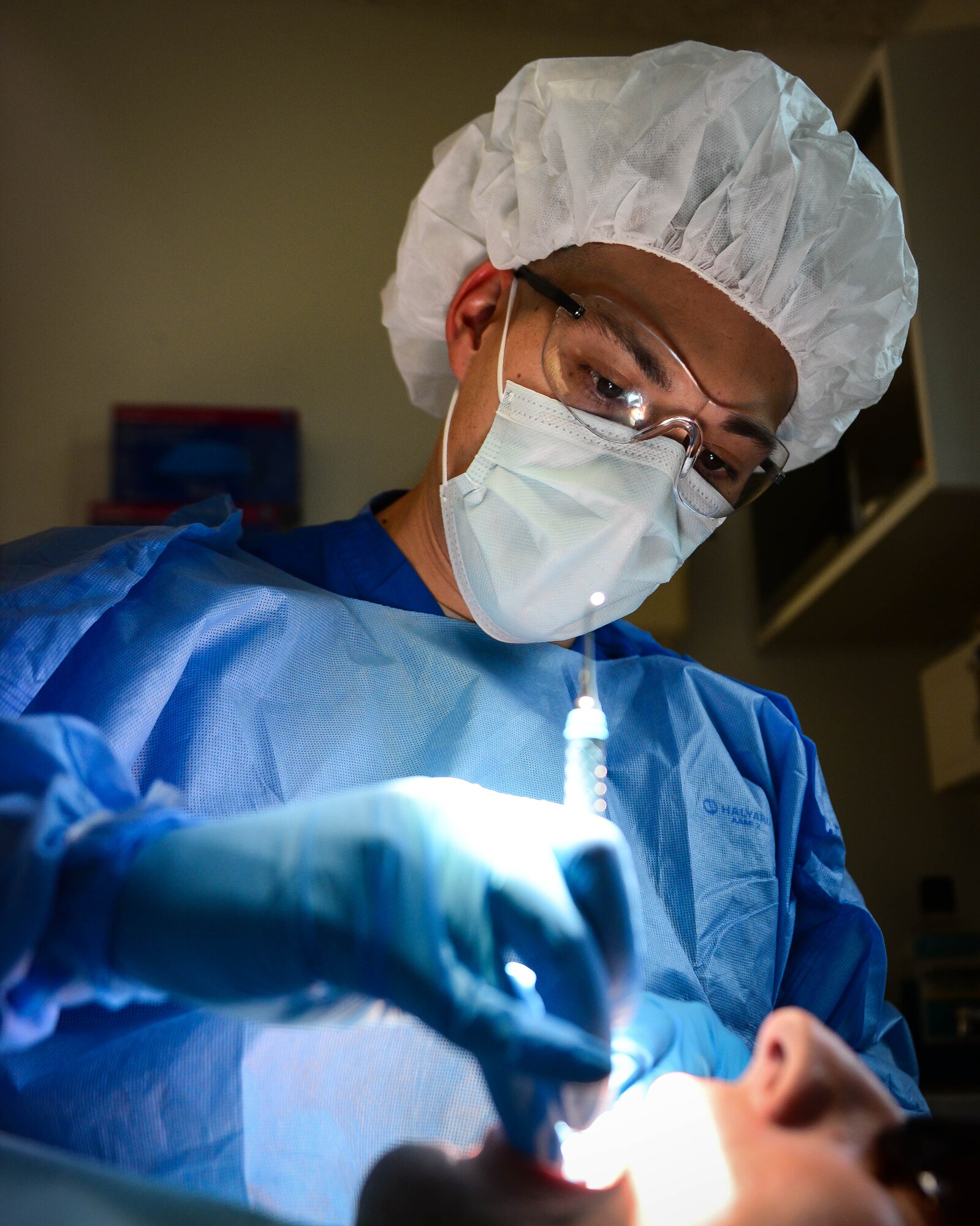 Staff Sgt. David Tierney, 2nd Dental Squadron dental technician, uses a scraper to remove plaque from a patient’s teeth at Barksdale Air Force Base, La., Sept. 14, 2016. Airmen are required to have their teeth cleaned once per year to help maintain good overall dental hygiene. (U.S. Air Force photo/Senior Airman Luke Hill) 