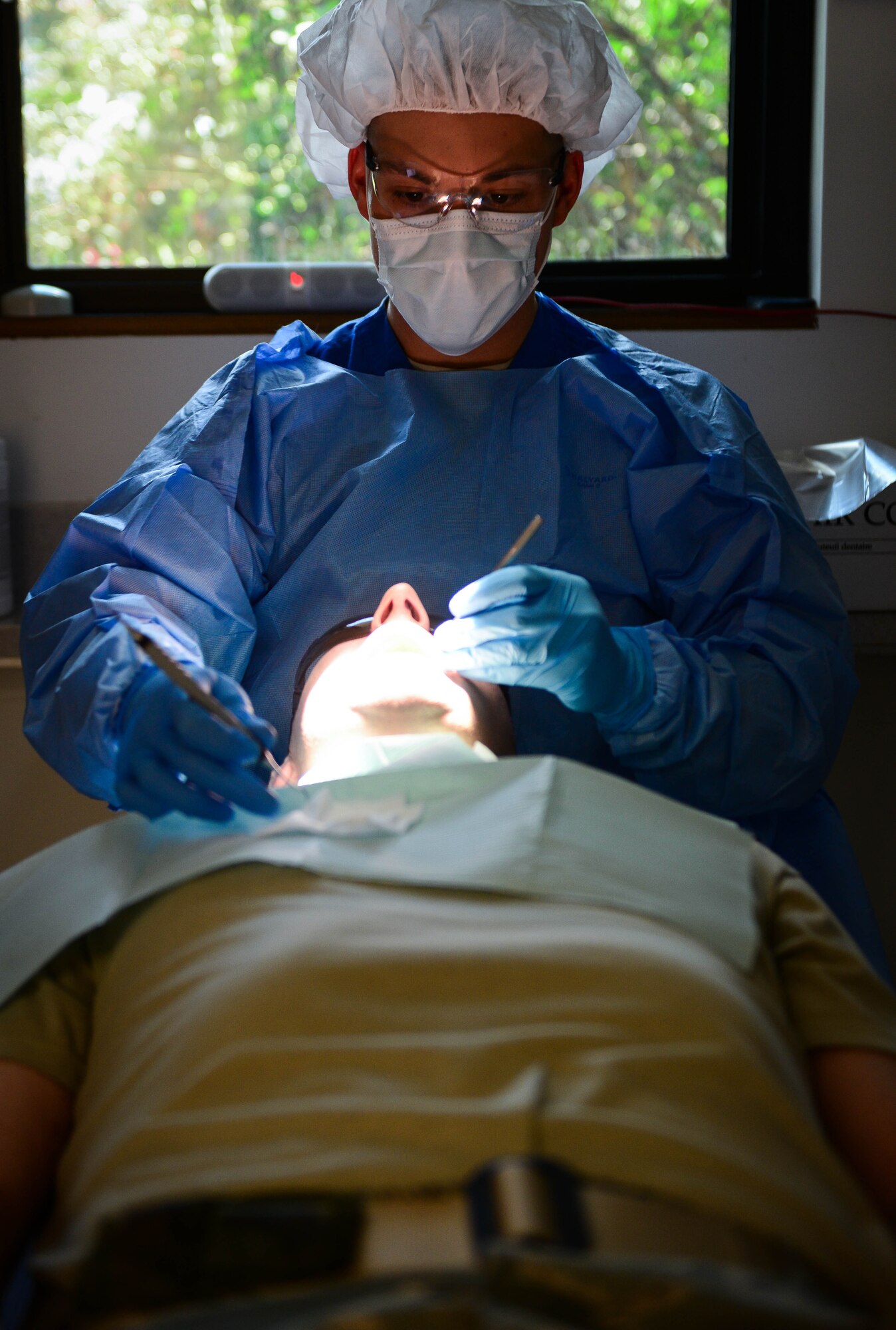 Staff Sgt. David Tierney, 2nd Dental Squadron dental technician, cleans a patient’s teeth at Barksdale Air Force Base, La., Sept. 14, 2016. During a cleaning, patients’ teeth are scraped, washed and coated with fluoride for protection. (U.S. Air Force photo/Senior Airman Luke Hill)