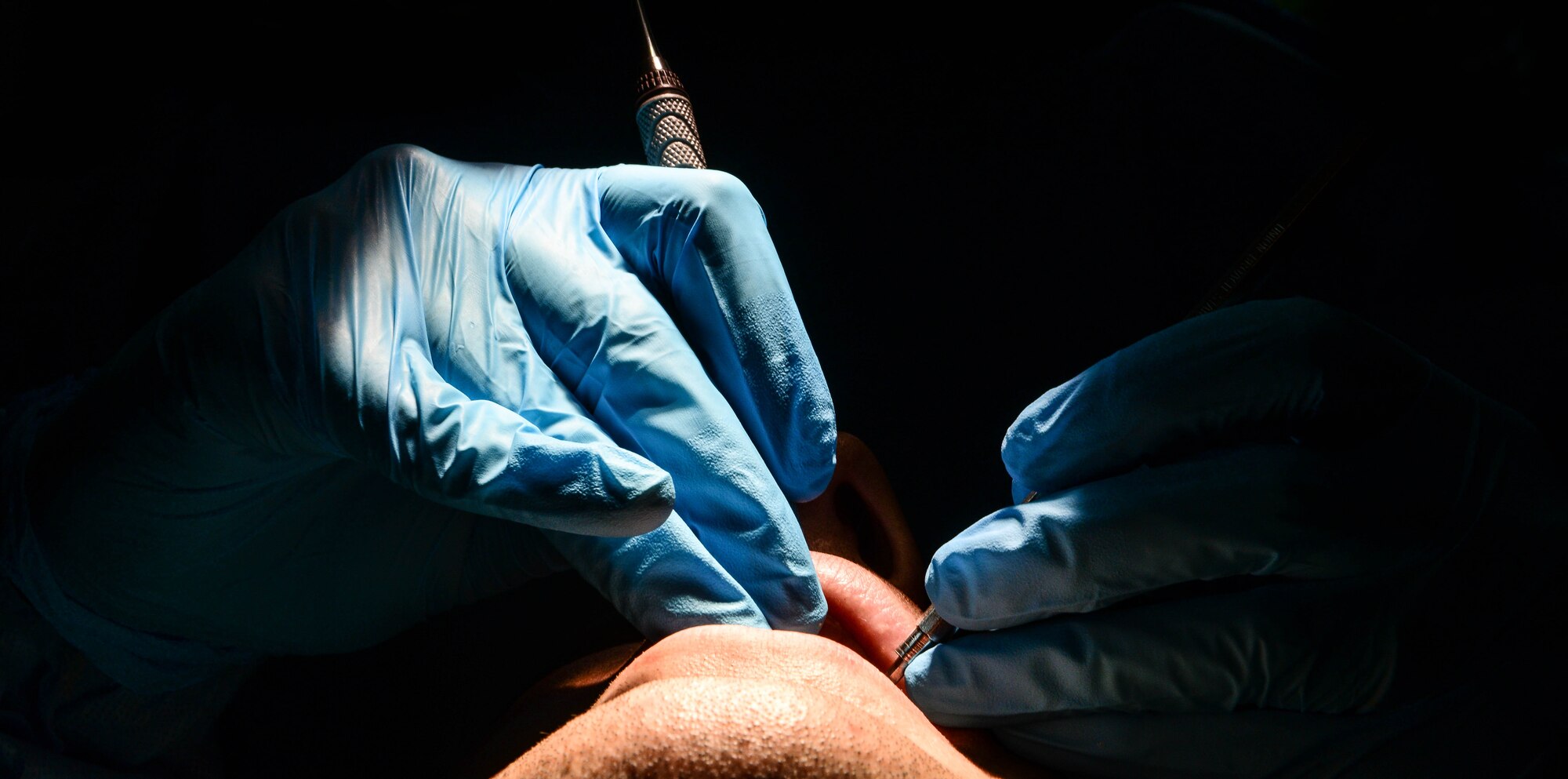 Staff Sgt. David Tierney, 2nd Dental Squadron dental technician, uses a scraper to remove plaque from a patients teeth at Barksdale Air Force Base, La., Sept. 14, 2016. Annual teeth cleanings give the 2nd DS an opportunity to track patients’ overall dental health. (U.S. Air Force photo/Senior Airman Luke Hill)