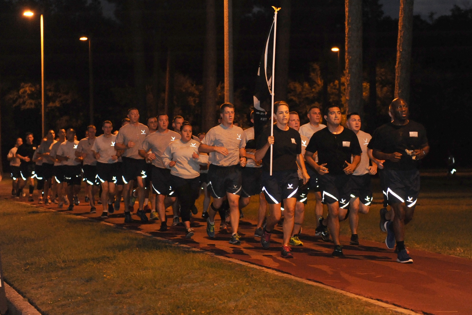 Col. Michele Edmondson, 81st Training Wing commander, and Chief Master Sgt. Vegas Clark, 81st TRW command chief, lead Keesler personnel in running the final lap during Keesler’s POW/MIA 24-hour memorial run and vigil at the Crotwell Track Sept. 16, 2016, on Keesler Air Force Base, Miss. More than 400 Keesler personnel participated in the event, to include runners and readers. Participants ran more than 1,500 miles and raised $1,400, which will be donated to a POW/MIA memorial fund. (U.S. Air Force photo by Kemberly Groue/Released)