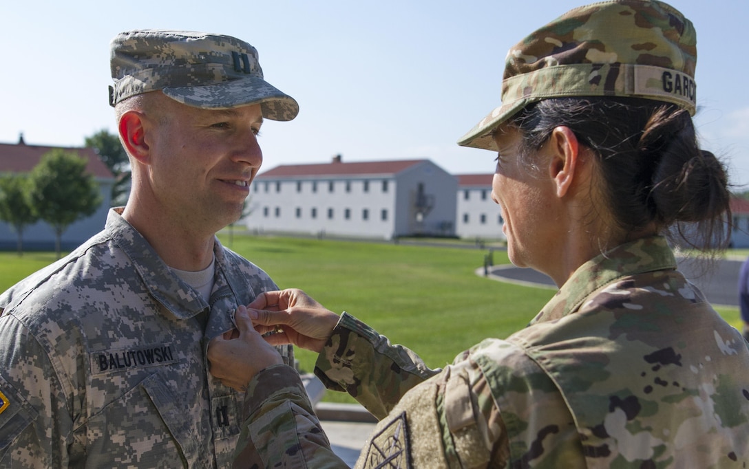 U.S. Army Reserve Brig. Gen. Marion Garcia, commander of the 200th Military Police Command, pins the Army Commendation Medal on Capt. James Balutowski, the operations officer for the 304th MP Battalion, July 18 during Warrior Exercise 86-16-03 at Fort McCoy, Wisc. Balutowski was awarded the General Douglas MacArthur Leadership Award for 2015. (U.S. Army Photo by Sgt. 1st Class Jacob Boyer)