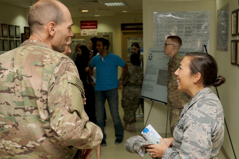 Air Force Capt. Gina McComb, a bioenvironmental engineer in the 386th Expeditionary Medical Group, briefs a Soldier during the U.S. Military Hospital-Kuwait Healthcare Symposium, September 4. The symposium was hosted by the 10th Combat Support Hospital to provide an open forum to healthcare professionals in all military branches and Kuwaiti professionals.