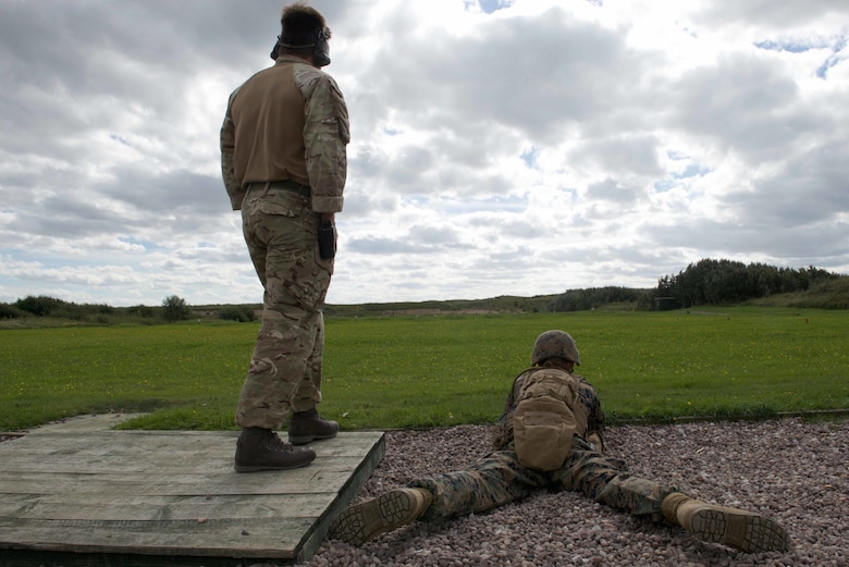 An instructor with the Royal Marines Combat Marksmanship Team observes a U.S. Marine with the Marine Corps Shooting Team adjust his SA80 A2 rifle, Sept. 11, 2016, at Altcar Training Camp, Merseyside, England. The Marines will be firing these weapons during the Royal Marines Operational Shooting Competition from September 6-22, 2016.  The U.S. Marines are competing against the Royal Netherlands Marine Corps and the Royal Marines. The U.S. Marines are with Weapons Training Battalion, Marine Corps Base Quantico, Virginia.