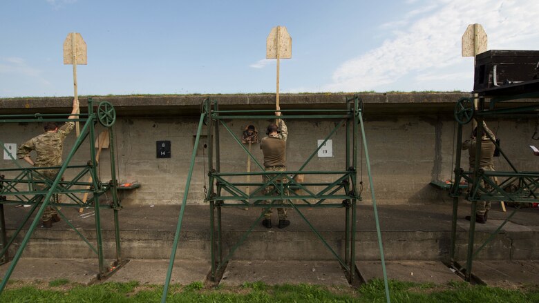 Royal Marines hold targets up to show competitors their scores Sept. 13, 2016, at Altcar Training Camp, Merseyside, England. The Marines are participating in the Royal Marines Operational Shooting Competition from Sept.  6-22, 2016.  The Royal Marines are competing against the Royal Netherlands Marine Corps and the U.S. Marines.