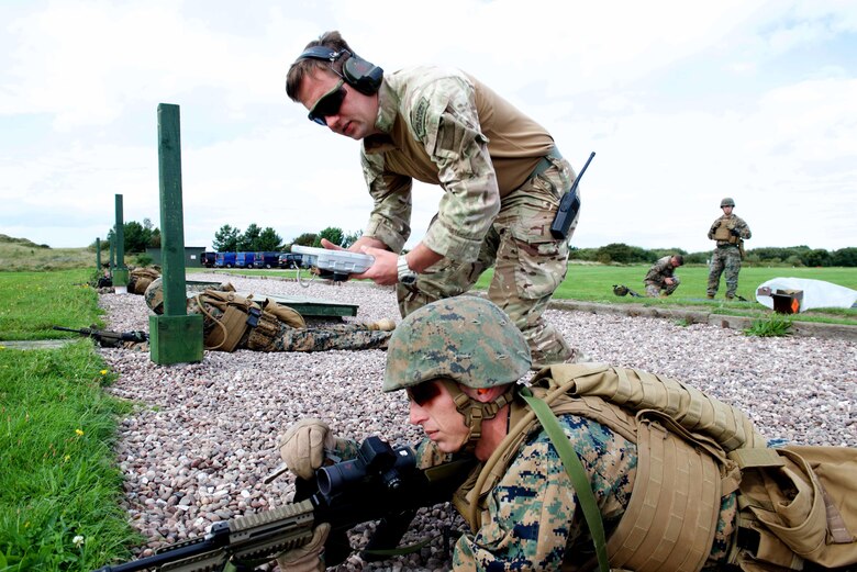 An instructor with the Royal Marines Combat Marksmanship Team tells Sgt. Aaron Meares, a competitor with the Marine Corps Shooting Team, what adjustments need to be made to his SA80 A2 rifle sight, Sept. 11, 2016, at Altcar Training Camp, Merseyside, England. The Marines will be firing these weapons during the Royal Marines Operational Shooting Competition from September 6-22, 2016.  The U.S. Marines are competing against the Royal Netherlands Marine Corps and the Royal Marines. The U.S. Marines are with Weapons Training Battalion, Marine Corps Base Quantico, Virginia.