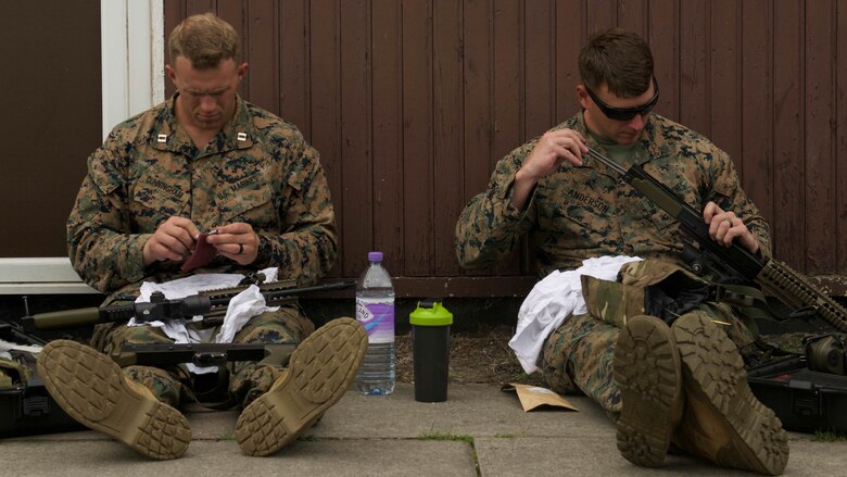 Capt. William Cunningham, left, and Sgt. Chris Anderson, competitors with the Marine Corps Shooting Team, clean their SA80 A2 rifles after a day of practice matches during the Royal Marines Operational Shooting Competition, Sept. 12, 2016, The Royal Marines are competing against and building bonds with the Royal Netherlands Marine Corps and the U.S. Marines. Cunningham and Anderson are with Weapons Training Battalion, Marine Corps Base Quantico, Virginia.