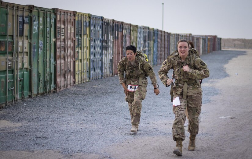 Soldiers ruck at sunrise carrying a 33-pound load as part of the German Armed Forces Proficiency Badge competition Aug. 3, 2016 at Camp Arifjan, Kuwait. Sixty-five service members from U.S. Army Central’s area of operations earned their German Armed Forces Proficiency Badge by participating in a four-day competition that tested soldier speed, agility, strength and endurance. (U.S. Army photo by Sgt. Angela Lorden)