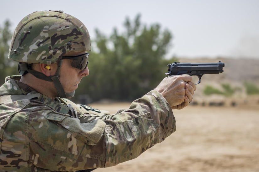 A U.S. Soldier fires at his target during the M9 pistol marksmanship event for a chance to earn his German Armed Forces Proficiency Badge on Aug. 4, 2016 at Camp Arifjan, Kuwait. The marksmanship event was the fourth and last test soldiers had to pass to earn the foreign badge. (U.S. Army photo by Sgt. Angela Lorden)