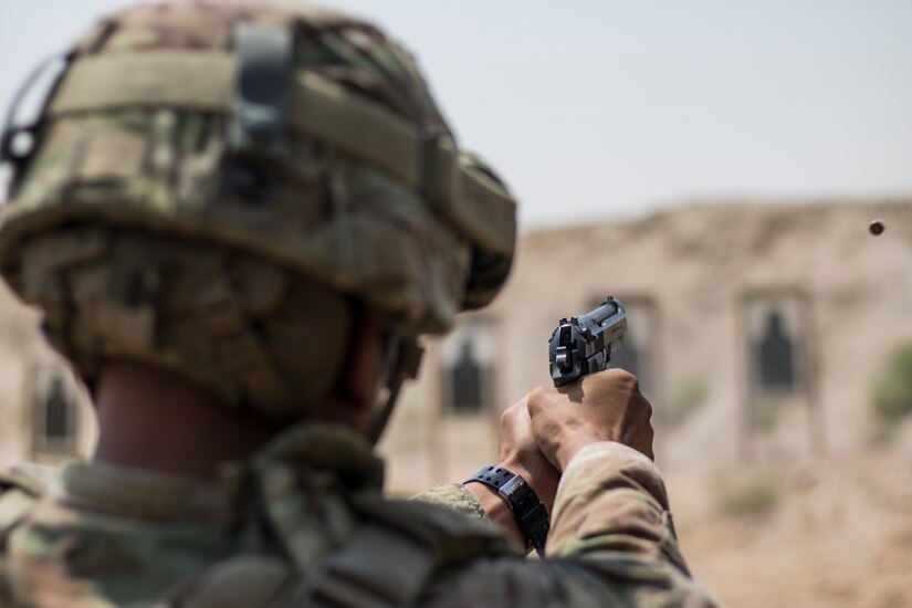 A U.S. Soldier fires his weapon during the M9 pistol marksmanship event for a chance to earn his German Armed Forces Proficiency Badge on Aug. 4, 2016 at Camp Arifjan, Kuwait. The marksmanship event was the fourth and last test soldiers had to pass to earn the foreign badge. (U.S. Army photo by Sgt. Angela Lorden)