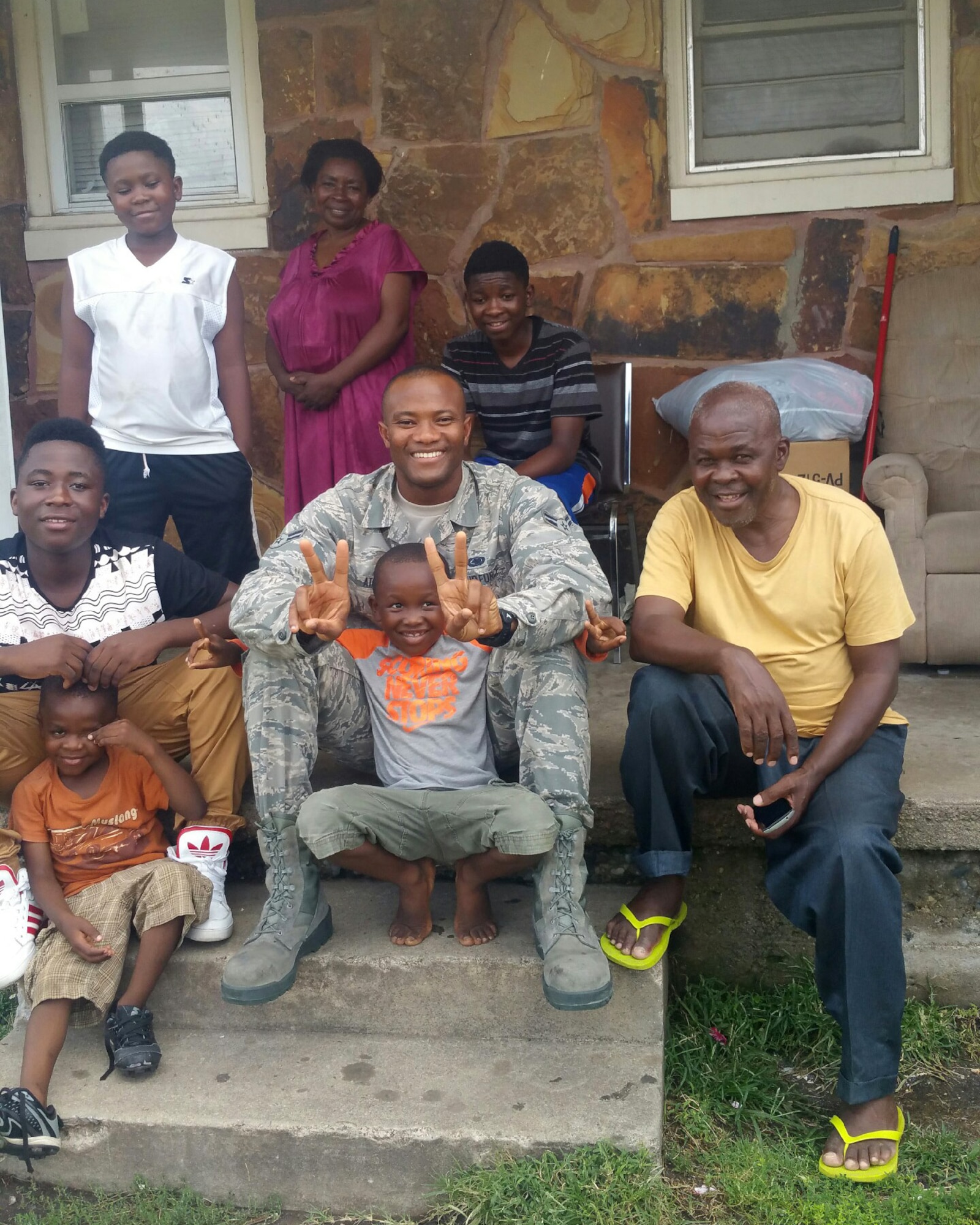 Airman 1st Class Messan Atayi, 22nd Logistics Readiness Squadron mobility Airman, poses for a photo with the Kamoune family in front of their home, Sept. 9, 2016, in Wichita, Kan. The Kamoune Family arrived in the United States in January 2016, as refugees from the Democratic Republic of Congo. (courtesy photo)