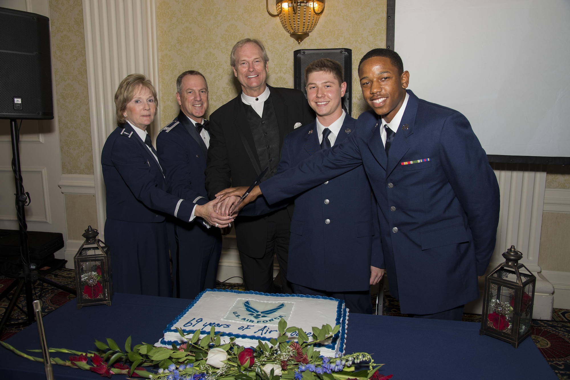 Team Dover’s most senior and junior members along with Dan Clark, guest speaker, prepare to cut the cake during the Air Force Ball Sept. 17, 2016, at Dover Downs in Dover, Del. It is Air Force tradition for the most senior and most junior members to cut the cake. (U.S. Air Force photo by Senior Airman Aaron J. Jenne)