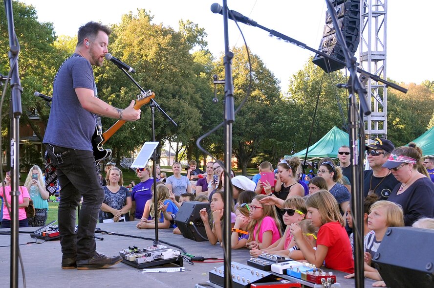 Members of Team Offutt and their families crowd the stage to see “American Idol” season seven winner David Cook during the Offutt Fall Fest, held Sept. 18, 2016 at Offutt Air Force Base, Nebraska. (U.S. Air Force photo by D.P. Heard/Released)