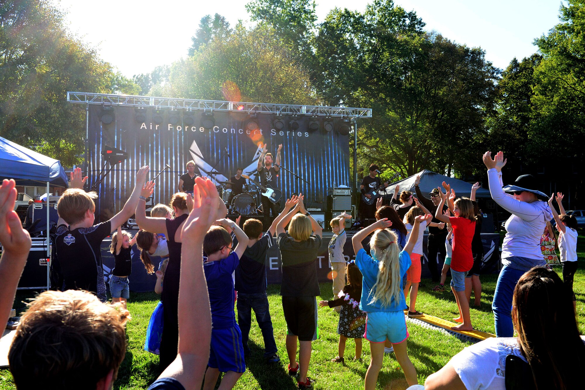 Members of Team Offutt and their families get into the swing of things as David Cook, singer, songwriter and “American Idol” season seven winner, performs at the 2016 Offutt Fall Fest, held Sept. 18, 2016 at Offutt Air Force Base, Nebraska. The concert was the thirteenth stop on a 16-base tour scheduled through the entertainment program of the Air Force Services Activity. The event included a concert, headlined by “American Idol” winner David Cook, as well as food trucks and children’s activities to include bouncy castles, face painting and sumo wrestling. (U.S. Air Force photo by Drew Nystrom/Released)