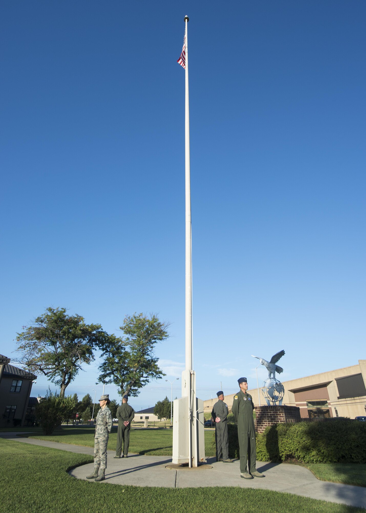 Col. Ethan Griffin, 436th Airlift Wing commander, Chief Master Sgt. Sarah Sparks, 436th AW command chief, Col. D. Scott Durham, 512th AW commander, and Chief Master Sgt. Steve West, 709th Airlift Squadron superintendent, stands during a vigil in acknowledgement of National POW/MIA Recognition Day Sept. 16, 2016, at the base flagpole on Dover Air Force Base, Del. These leaders represent both the active duty and Reserve components that make up Team Dover. (U.S. Air Force photo by Senior Airman Zachary Cacicia)