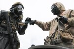 U.S. Army Pfc. Kemper Baker, 4th Battalion, 23rd Infantry Regiment, 2nd Stryker Brigade, 2nd Infantry Division, hands a brush back to a Japan Force Ground Self-Defense member, 3rd Nuclear Biological Chemical unit, 3rd Div., 36th Inf. Reg at Aibano Training Area, Japan, Sept. 15, 2016. The Infantrymen go through the Japanese personnel decontamination process, which includes cleaning their equipment at a wash station.