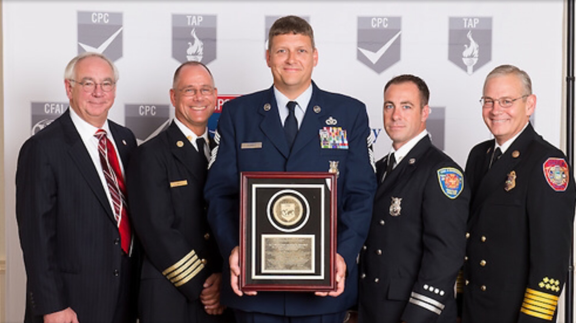 Chief Master Sgt. Andy Morris, 436th Civil Engineer Squadron Fire Department fire chief, holds the Commission on Fire Accreditation International plaque Aug. 17, 2016, at the CFAI Headquarters in Houston, Texas. Members of the 436th CES Fire Department devoted three years to self-evaluating and improving to complete CFAI’s requirements. (Courtesy photo)