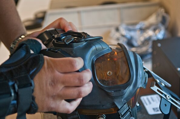 Senior Airman Zachary Hazuka, a mobility readiness spears package journeyman with the 5th Logistics Readiness Squadron, connects a chemical protection mask to a joint service mask tester in the 5th LRS’s Individual Protective Equipment shop at Minot Air Force Base, N.D., Sept. 6, 2016. These masks provide eye, face and respiratory protection against chemical agents and radioactive particles. (U.S. Air Force photo/Airman 1st Class Jonathan McElderry)
