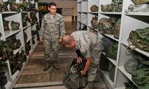 Senior Airman Zachary Hazuka, a central storage apprentice with the 5th Logistics Readiness Squadron, packs deployment training gear into a duffle bag at Minot Air Force Base, N.D., Sept. 6, 2016. The IPE shop is responsible for issuing out chemical gear for all deploying Airmen. (U.S. Air Force photo/Airman 1st Class Jonathan McElderry)