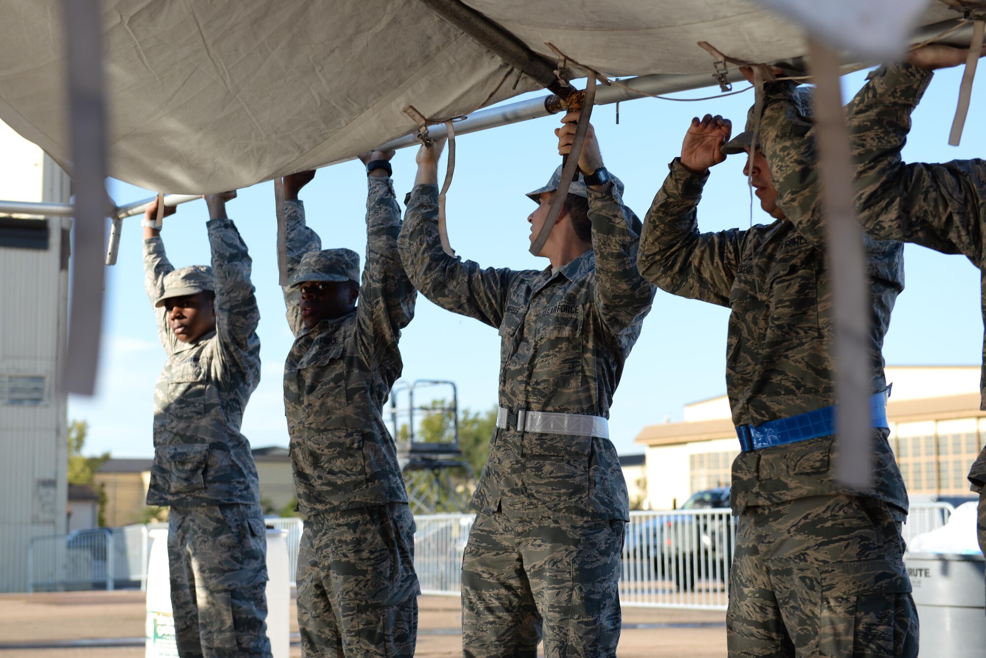 U.S. Air Force Airmen help reset tents after a storm blew down nearly every tent for the Sheppard Air Force Base, Texas, Open House and Air Show, Sept. 18, 2016. More than 2,000 Airmen in Training gathered to help reset the base for the 75th Anniversary Air Show Celebration. (U.S. Air Force photo by Senior Airman Kyle E. Gese)