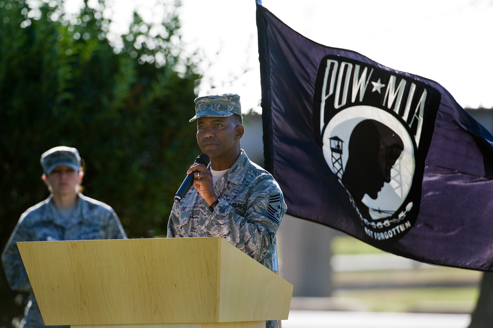 Retired Chief Master Sgt. Larence Kirby speaks to Team Dover members and guests during a retreat ceremony commemorating National POW/MIA Recognition Day Sept. 16, 2016, on Dover Air Force Base, Del. More than 130 fallen service members from previous wars and conflicts have been repatriated this past year. (U.S. Air Force photo by Roland Balik)