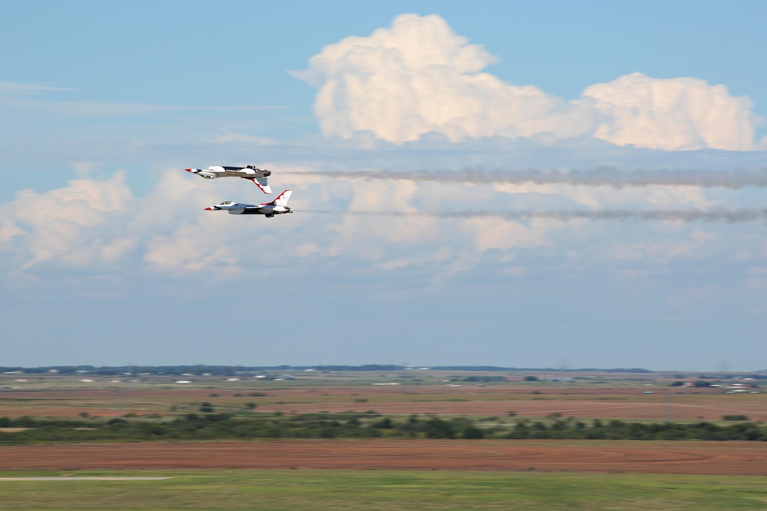 The U.S. Air Force Thunderbird numbers 5 and 6 perform a Calypso Pass maneuver during the 75th Anniversary Air Show Celebration at Sheppard Air Force Base, Texas, Sept. 17, 2016. Since 1953, the Thunderbirds have performed for millions of people across the United States, spreading the word about the U.S. Air Force and its precision, skill and decisive combat power. (U.S. Air Force photo by Senior Airman Kyle E. Gese)