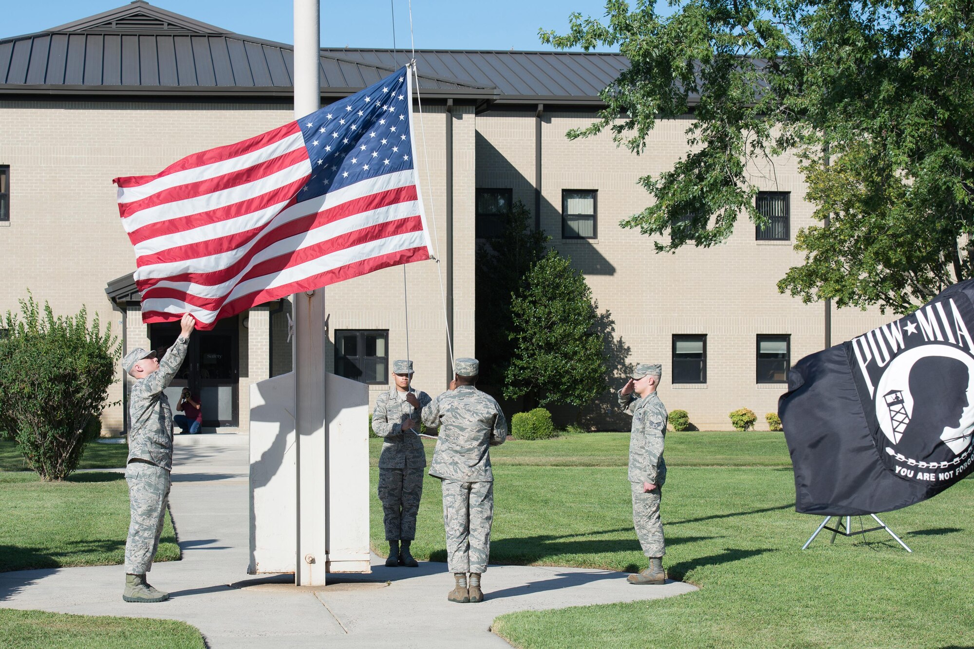 Members of Team Dover lower the colors to conclude the National POW/MIA Recognition Day Ceremony Sept. 16, 2016, at Dover Air Force Base, Del. The ceremony is held annually to honor American prisoners of war and those still missing in action. (U.S. Air Force photo by Mauricio Campino)