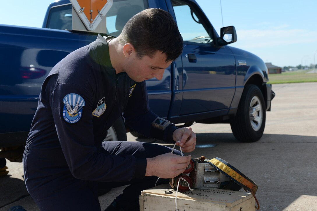 Air Force Cadet Everett Joiner prepares smoke grenades for the U.S. Air Force Wings of Blue parachute team’s performance at the Sheppard Air Force Base, Texas, 75th Anniversary Air Show Celebration, Sept. 17, 2016. The Wings of Blue runs the Air Force’s basic freefall parachuting course which is the only certified first-jump program in the world where students can make their first freefall jump without assistance. (U.S. Air Force photo by Senior Airman Kyle E. Gese)