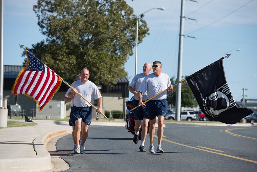 Chief master sergeants from the 436th Airlift Wing run the last lap of the National POW/MIA Recognition Day Run Sept. 16, 2016, at Dover Air Force Base, Del. Team Dover Airmen ran in shifts over the 24-hour period preceding the retreat ceremony. (U.S. Air Force photo by Mauricio Campino)