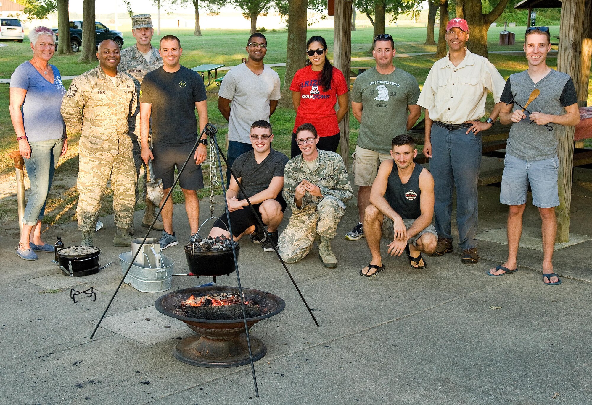 Dorm to Gourm participants pose for a photo Sept. 13, 2016, at the Eagle’s Nest picnic area on Dover Air Force Base, Del. Col. Randy Boswell, 436th Mission Support Group commander, Senior Airmen William Johnson and Zachary Cacicia, 436th Airlift Wing photojournalists, demonstrated how to prepare and cook beef stew, chicken, lasagna and blueberry cobbler using Dutch ovens during the Dorm to Gourm class. (U.S. Air Force photo by Roland Balik)
