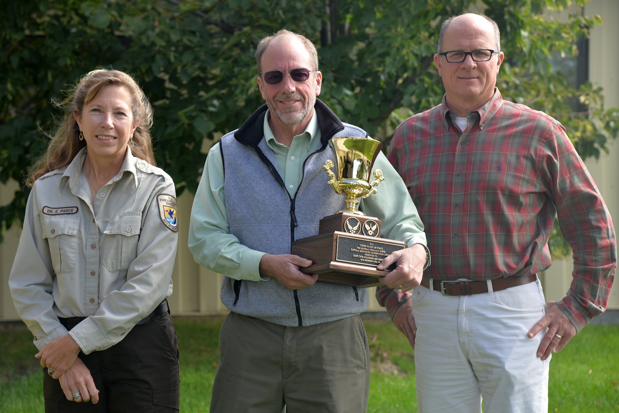 From left to right: Elin Pierce, U.S. Fish and Wildlife Services biologist; Rudy Verzuh, 341st Civil Engineer Squadron installation management flight chief; and Tony Lucas, 341st CES environmental section chief, pose for a picture with their 2016 Gen. Thomas D. White National Resources Conservation Award Sept. 19, 2016, at Malmstrom Air Force Base, Mont. This annual award recognizes the installation with the best or most improved natural resources management program during the previous three fiscal years and who emphasizes its program improvements and initiatives, achieved objectives, interagency cooperation, community relations, conservation education and command support. (U.S. Air Force photo/Airman 1st Class Daniel Brosam)