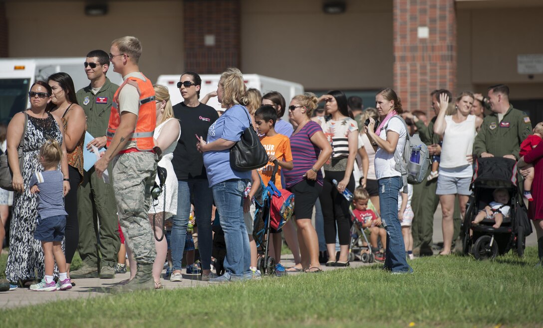 Family, friends and co-workers wait to greet Airmen returning from a deployment at Dyess Air Force Base, Texas, Sept. 19, 2016. Sixty-seven Airmen from the 317th Airlift Group and 7th Bomb Wing were deployed for four months to support ongoing operations in Djibouti, Africa. (U.S. Air Force photo by Airman 1st Class Rebecca Van Syoc)