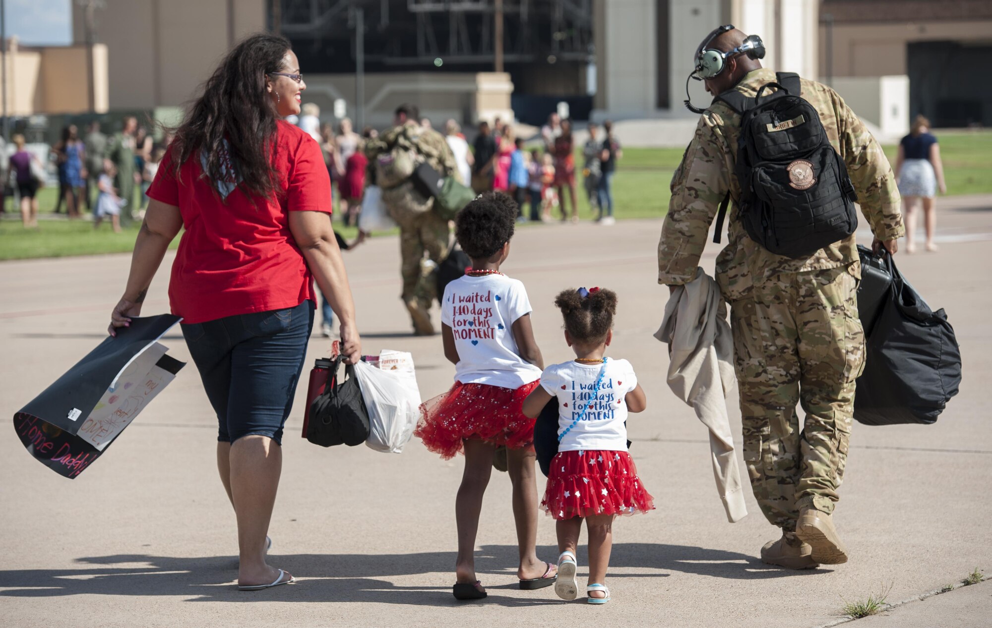 The Griffin family walks off the flightline after welcoming home Master Sgt. Larry Griffin, 39th Airlift Squadron, at Dyess Air Force Base, Texas, Sept. 19, 2016. Griffin returned after a four month deployment supporting operations in Djibouti, Africa. The Airmen supported ongoing humanitarian, airlift, airdrop and aeromedical evacuation missions in the U.S. Central Command area of responsibility in Africa. (U.S. Air Force photo by Airman 1st Class Rebecca Van Syoc).