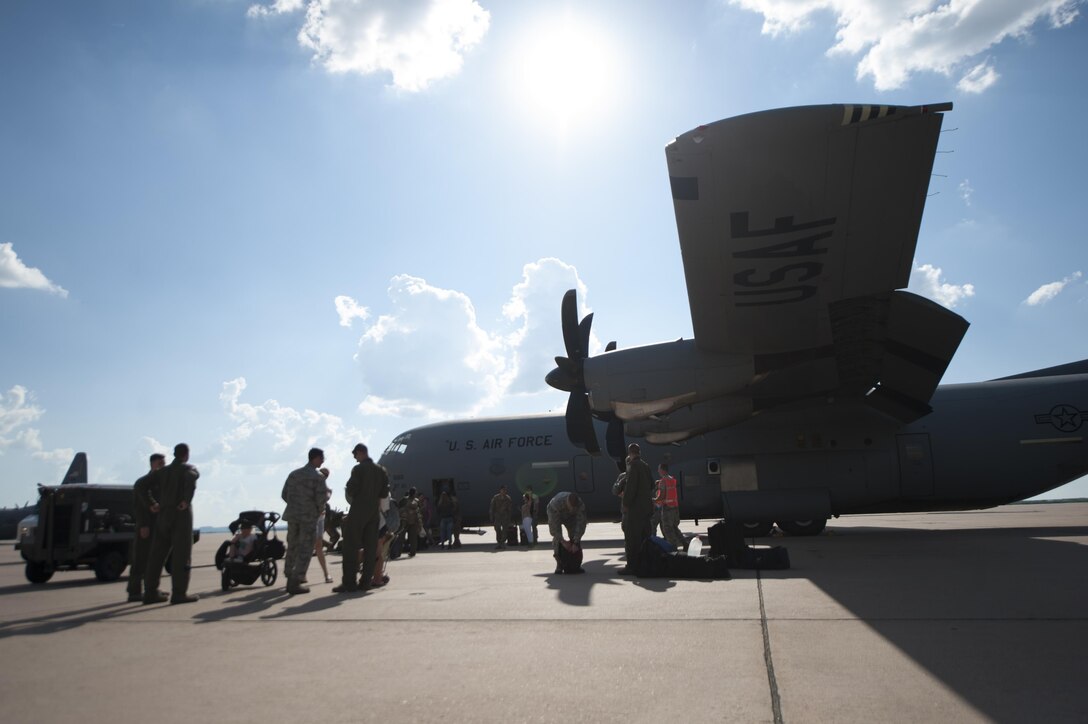 U.S. Air Force Airmen from the 317th Airlift Group and 7th Bomb Wing unload luggage from a C-130J Super Hercules after returning from a deployment at Dyess Air Force Base, Texas, Sept. 19, 2016. The redeployed Airmen were greeted by family, friends and co-workers with welcome signs and gifts. (U.S. Air Force photo by Airman 1st Class Rebecca Van Syoc)