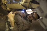 U.S. Marine Cpl. Ernesto VegaHernandez conducts a joint limited technical inspection of a recently refurbished Mine Resistant Ambush Protected vehicles, and the lighter version--MATV or MRAP All-Terrain Vehicle. The Kendall, Fla. native was a part of a select group of mechanics and communications maintainers with Combat Logistics Battalion 5, Special Purpose Marine Air Ground Task Force – Crisis Response – Central Command tasked with ensuring the vehicles were ready to be shipped to Iraq, where Marines are supporting Iraqi Security Forces in the fight against the Islamic State of Iraq and the Levant. SPMAGTF – CR – CC is a self-sustaining expeditionary unit, designed to provide a broad range of crisis response capabilities throughout the Central Command area of responsibility, using organic aviation, logistical, and ground combat assets. (Photo by SSgt. Lynn Kinney/ Released)