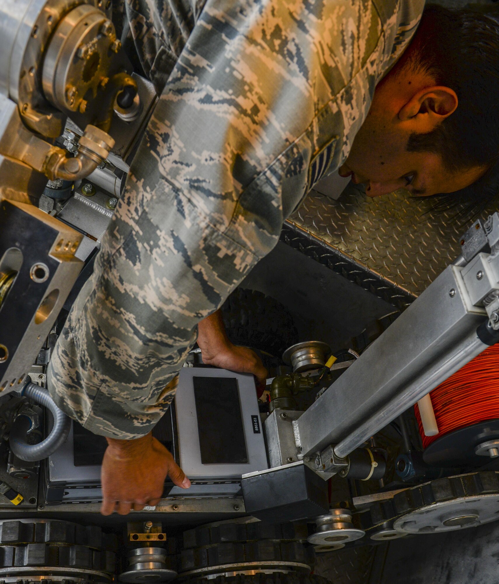 Senior Airman Larry Sanchez, 8th Civil Engineer Squadron Explosive Ordnance Disposal technician, loads a battery into the Andros F-6 robot during a training exercise at Kunsan Air Base, Republic of Korea, Aug. 30, 2016. EOD members use the robot in situations to identify unknown explosives before sending in airmen. (U.S. Air Force photo by Senior Airman Colville McFee/Released)