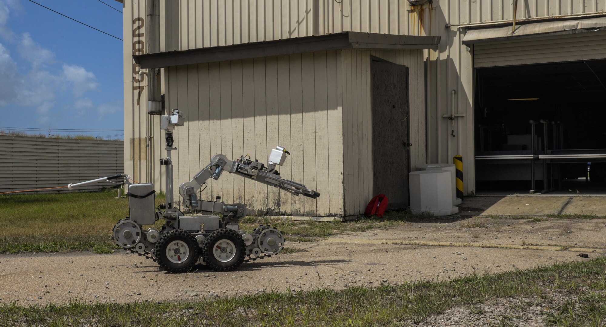 An Andros F-6 robot used by U.S. Air Force Explosive Ordnance Disposal members, 8th Civil Engineer Squadron, maneuvers around the side of a building to get a view of an unidentified item during a training exercise at Kunsan Air Base, Republic of Korea, Aug. 30, 2016. EOD members use the robot in situations to identify unknown explosives before sending in airmen. (U.S. Air Force photo by Senior Airman Colville McFee/Released)