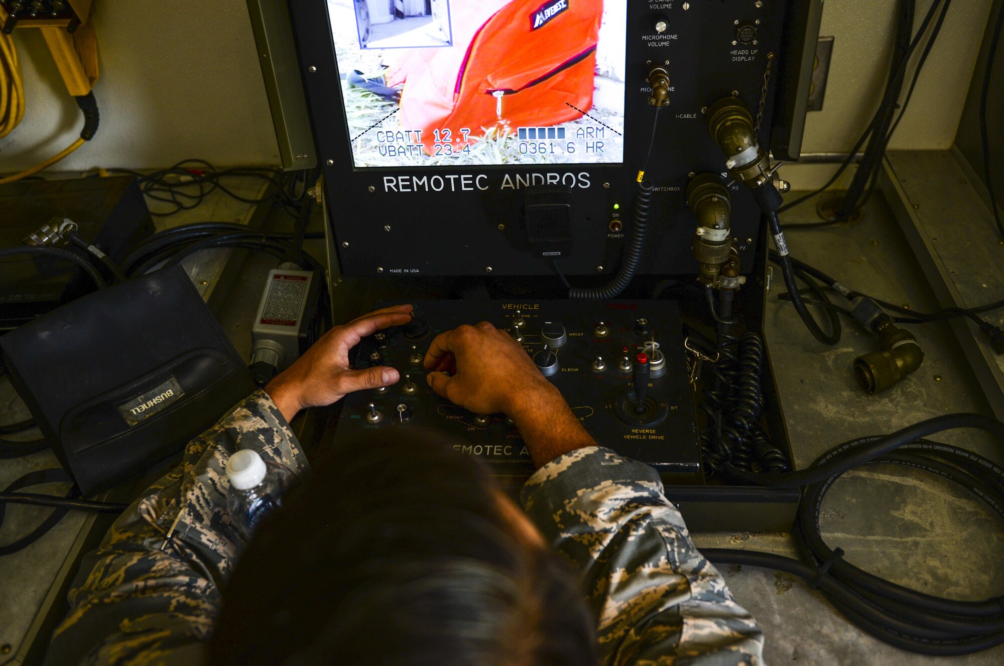 Senior Airman Larry Sanchez, 8th Civil Engineer Squadron Explosive Ordnance Disposal technician, uses remote controls to maneuver an Andros F-6 robot during a training exercise at Kunsan Air Base, Republic of Korea, Aug. 30, 2016. EOD members use the robot in situations to identify unknown explosives before sending in airmen. (U.S. Air Force photo by Senior Airman Colville McFee/Released)