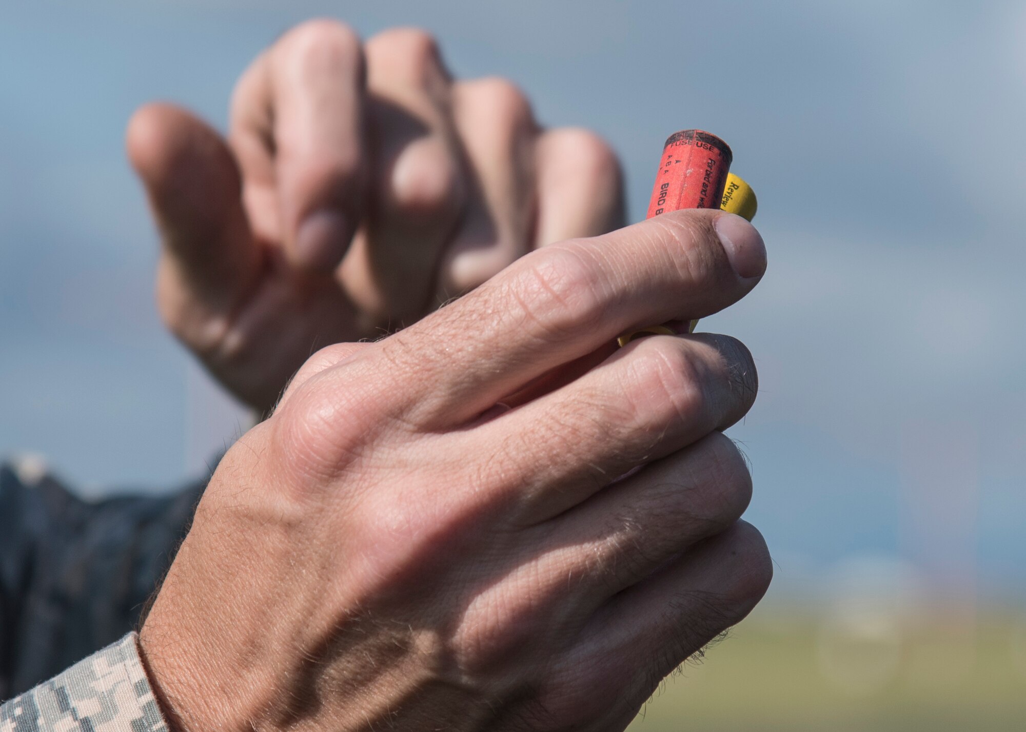 U.S. Air Force Master Sgt. Curtis Campbell, a bird aircraft strike coordinator with the 35th Fighter Wing, shows two of three types of ammunition used to scare animals away from the flightline at Misawa Air Base, Japan, Sept. 15, 2016. The ammunition used by the BASH team includes cracker, birdshot and buckshot rounds. (U.S. Air Force photo by Airman 1st Class Sadie Colbert)