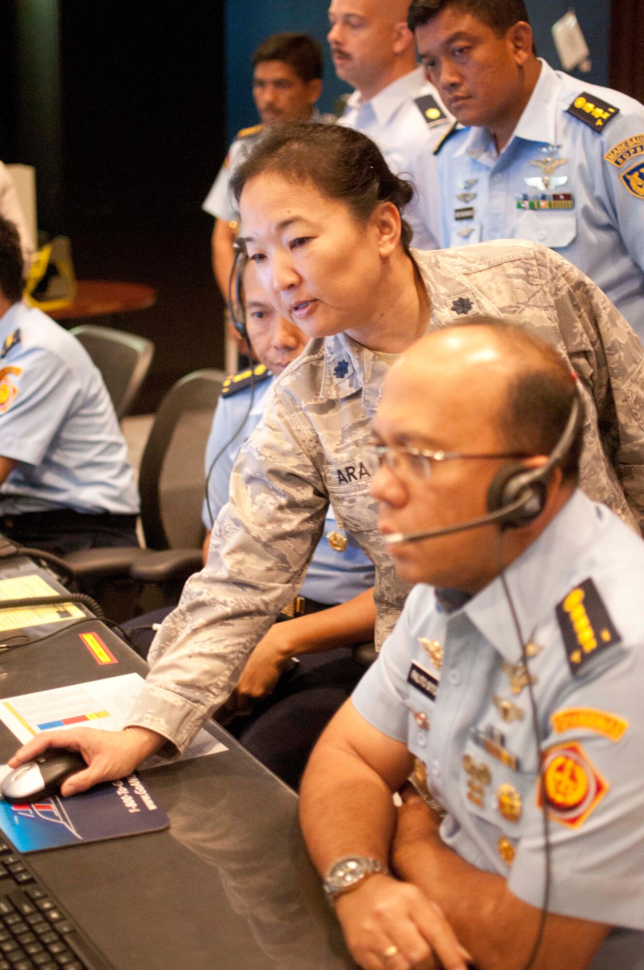 U.S. Air Force Lt. Col. Gaye Araki from the Hawaii Air National Guard's 169th Air Defense Squadron assists in showing the Indonesian air defense delegation an exercise involving the scrambling of fighter jets responding to a potential threat in the Hawaii air space, Aug. 30 2016, Wheeler Army Airfield, Hawaii. This is the second time a Subject Matter Expert Exchange between the Indonesian air defense and the 169th Air Defense Squadron has been conducted and the first time the Indonesians have come to Hawaii. (U.S. Air National Guard photo by Airman 1st Class Stan Pak/released)