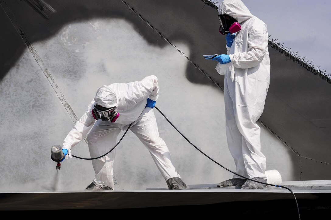 Airmen spray a coating of paint onto a General Dynamics FB-111A Aardvark, which was a supersonic tactical attack aircraft, at Whiteman Air Force Base, Mo., Sept. 13, 2016. During the restoration process, crews sanded, primed and repainted the aircraft. The airmen are low observable technicians assigned to the 509th Maintenance Squadron. Air Force photo by Senior Airman Joel Pfiester