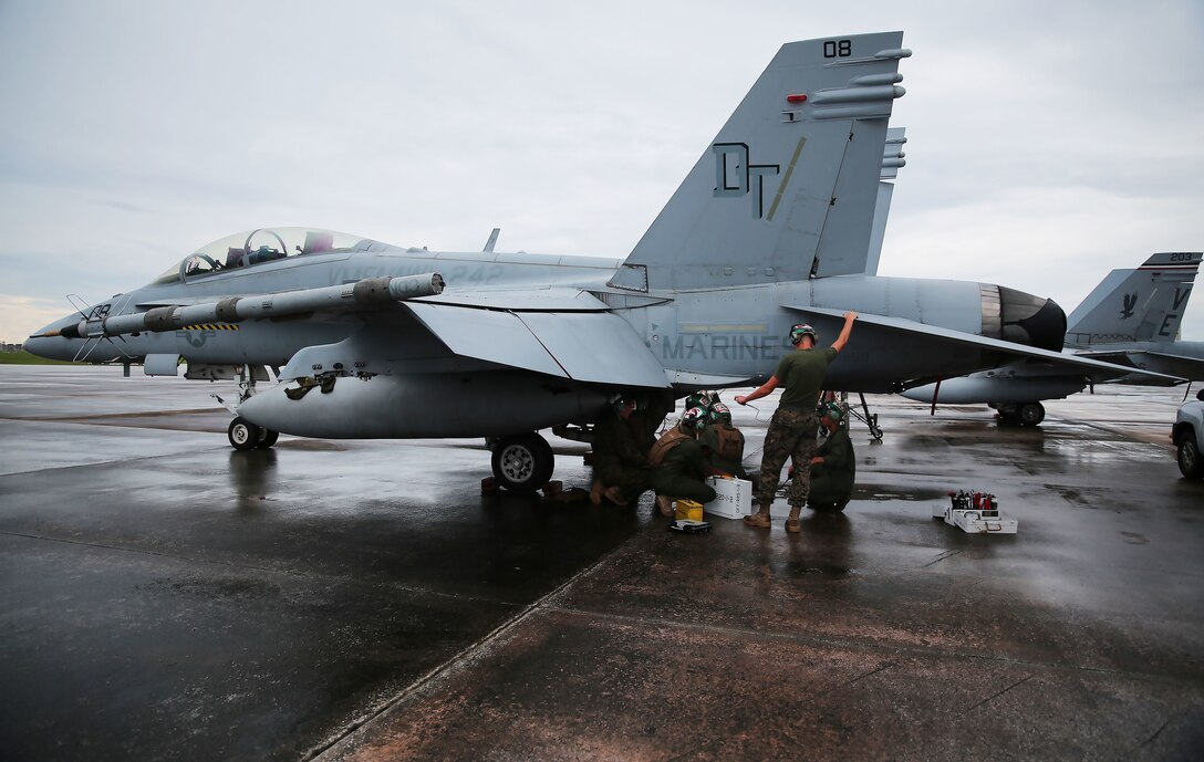 Powerliners assigned to Marine All Weather Fighter Attack Squadron (VMFA(AW)) 242 perform maintenance on an F/A-18D Hornet after a flight mission during Exercise Valiant Shield 16 at Andersen Air Force Base, Guam, Sept. 18, 2016. Powerliners, airframes mechanics, communication navigation, and ordnance technicians, work around the clock to ensure flight schedules are met for aviation operations during the exercise. During this U.S.-only, biennial field training exercise, F/A-18D Hornets flew in a plethora of missions that emphasize joint integration, interoperability and expeditionary readiness. (U.S. Marine Corps photo by Sgt. Jessica Quezada)