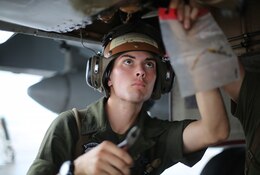 Lance Cpl. Nick Cox, a powerliner assigned to Marine All Weather Fighter Attack Squadron (VMFA(AW)) 242 performs maintenance on an F/A-18D Hornet after a flight mission during Exercise Valiant Shield 16 at Andersen Air Force Base, Guam, Sept. 18, 2016. Powerliners, airframes mechanics, communication navigation, and ordnance technicians, work around the clock to ensure flight schedules are met for aviation operations during the exercise. During this U.S.-only, biennial field training exercise, F/A-18D Hornets flew in a plethora of missions that emphasize joint integration, interoperability and expeditionary readiness. (U.S. Marine Corps photo by Sgt. Jessica Quezada)